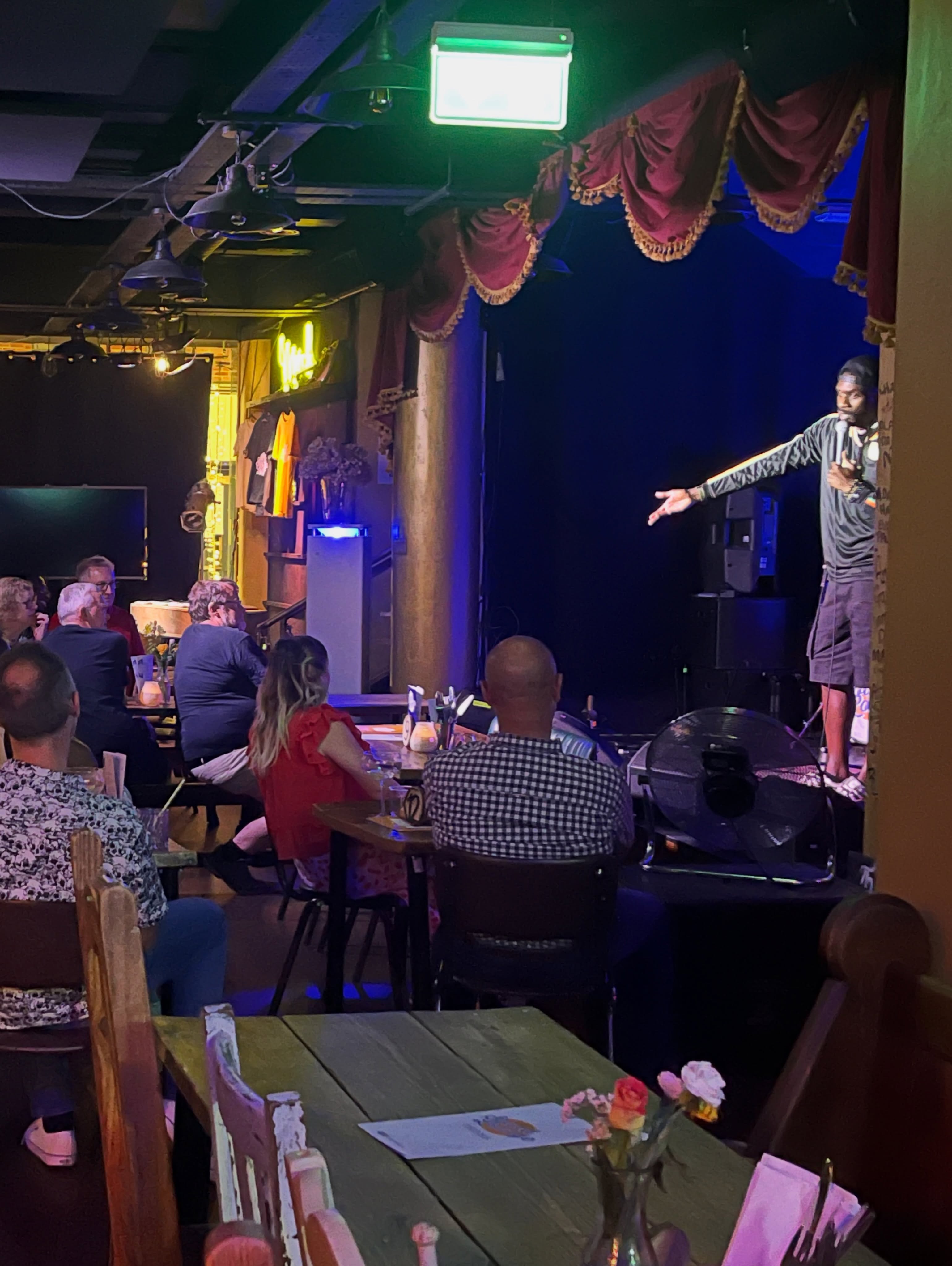 A comedian performing beside the Sound Lounge stage