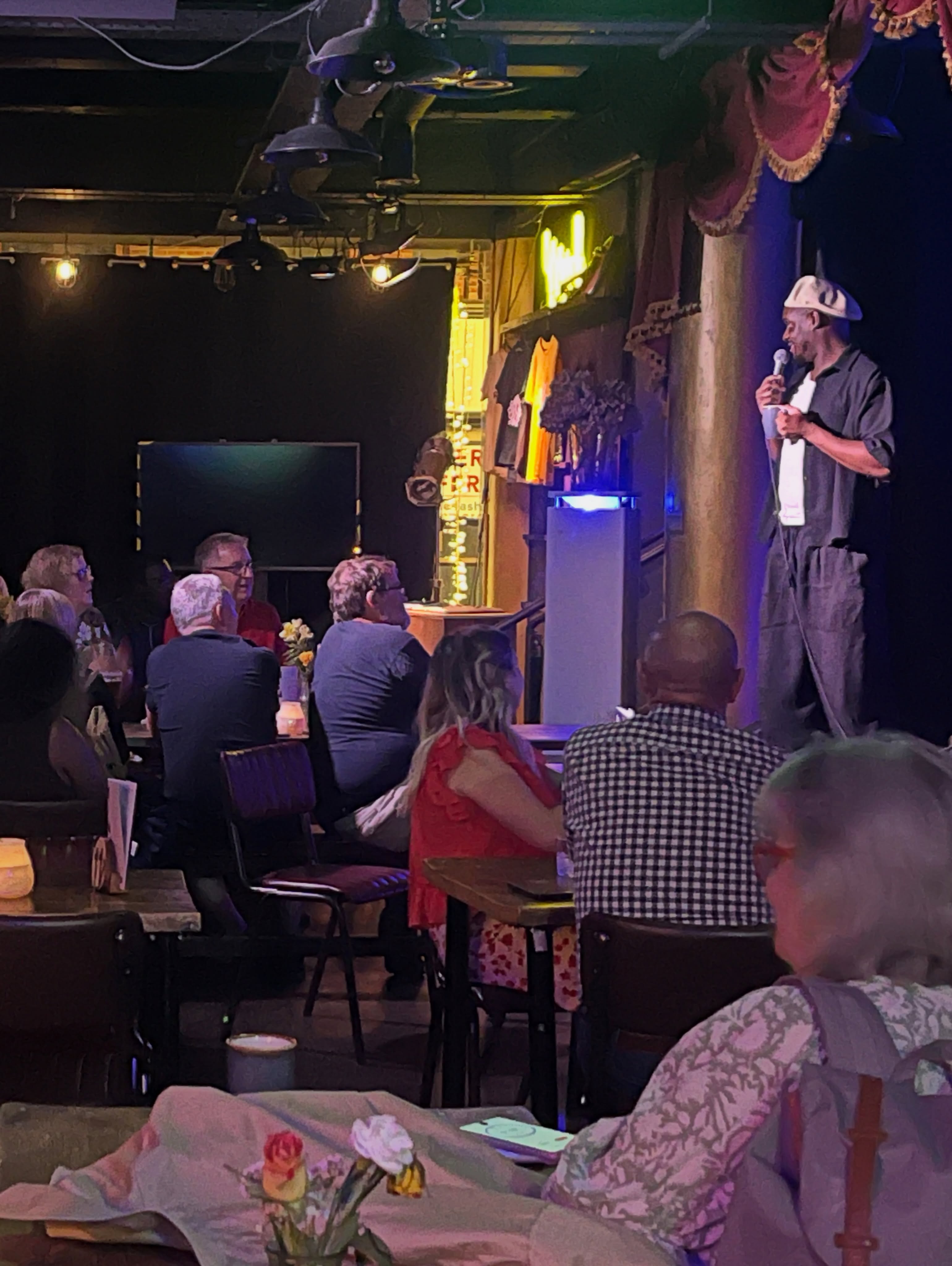 A comedian performing at the front of The Sound Lounge