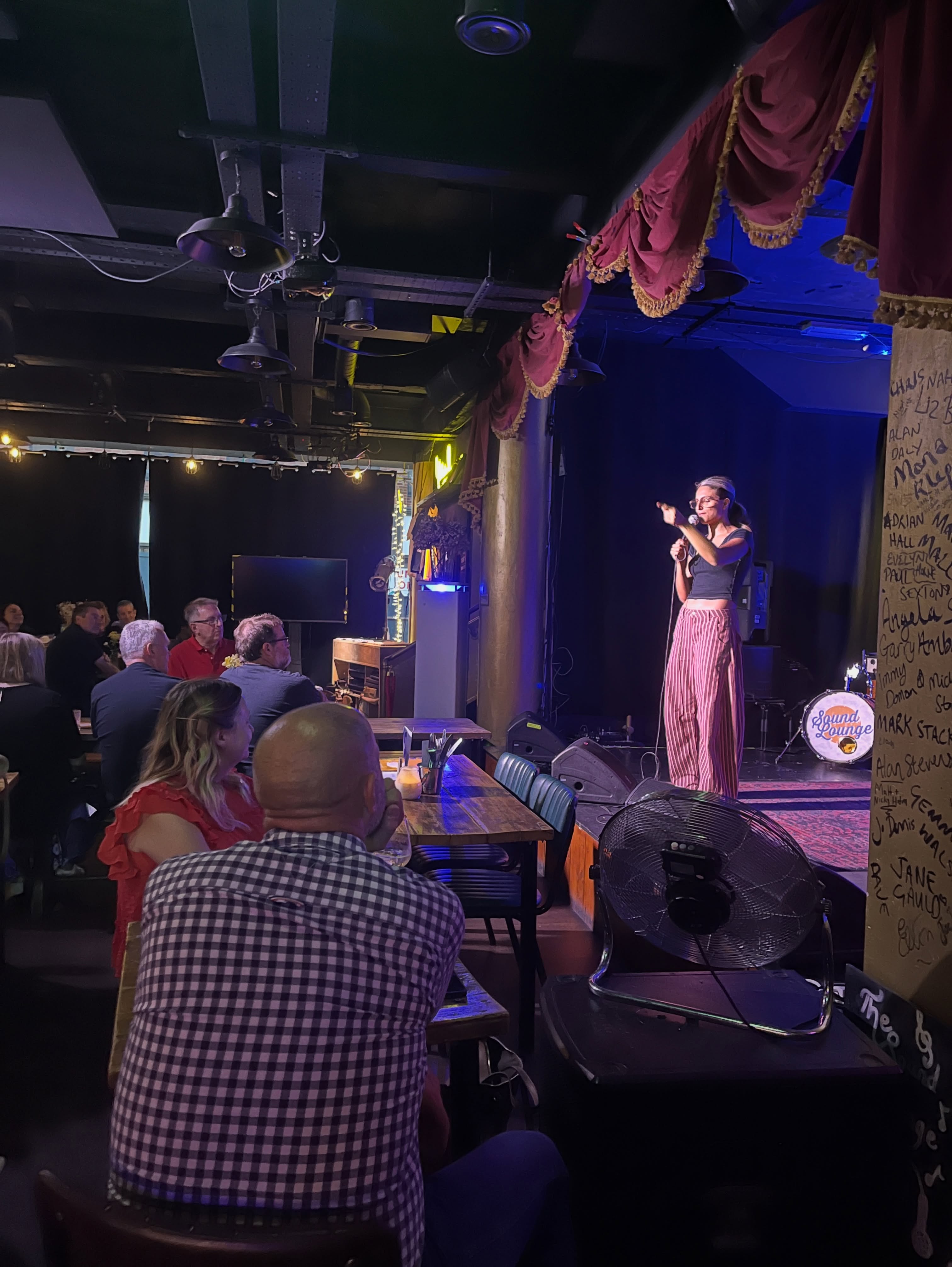A comedian performing to the seated Sound Lounge audience